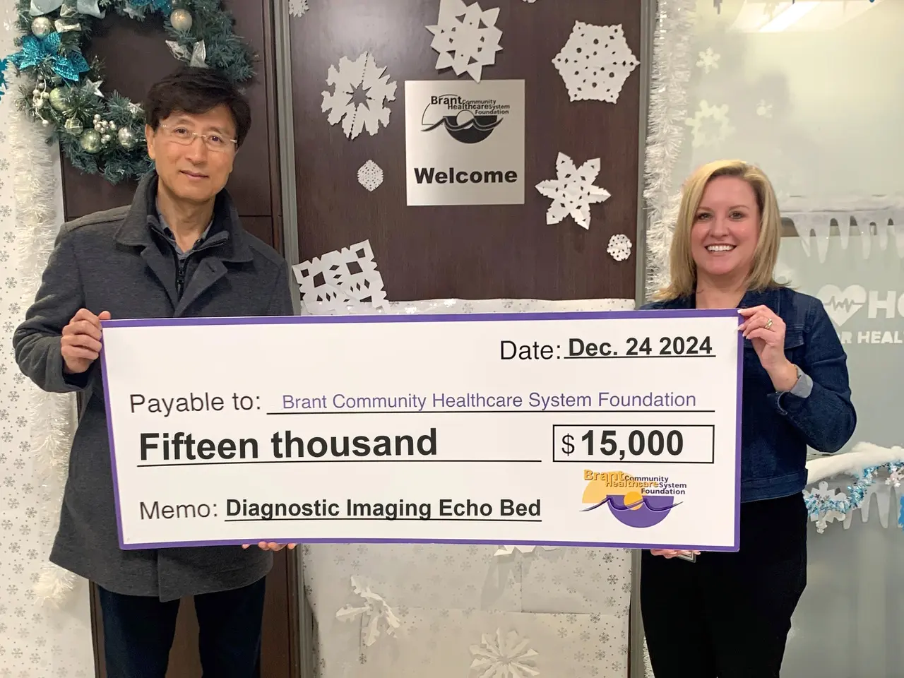 Dr. Kim presenting a charitable donation cheque to the Brant Community Healthcare System Foundation in support of diagnostic imaging services in Brantford.